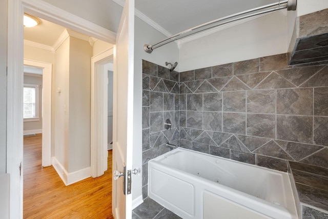 bathroom featuring hardwood / wood-style flooring, ornamental molding, and shower / tub combination