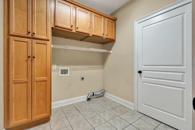 clothes washing area featuring light tile patterned floors, baseboards, cabinet space, electric dryer hookup, and washer hookup