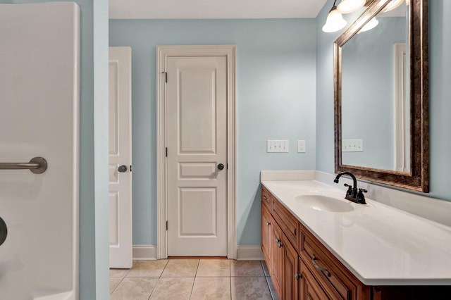 bathroom featuring vanity, tile patterned floors, and baseboards