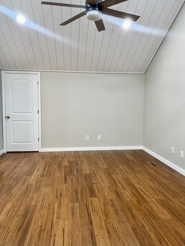 additional living space featuring visible vents, vaulted ceiling, baseboards, and wood finished floors