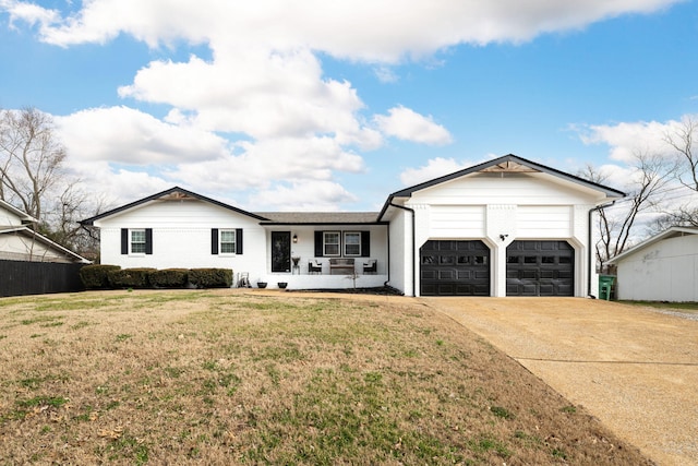 view of front of property with a porch, a garage, and a front yard