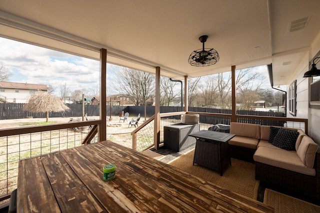 wooden terrace featuring an outdoor living space with a fire pit