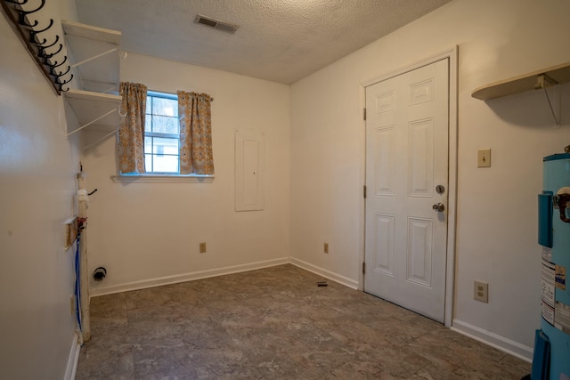 washroom with electric panel, electric water heater, and a textured ceiling