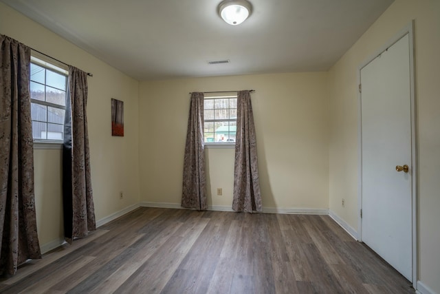empty room featuring wood-type flooring