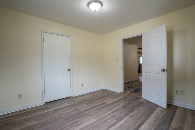 unfurnished room featuring dark hardwood / wood-style flooring