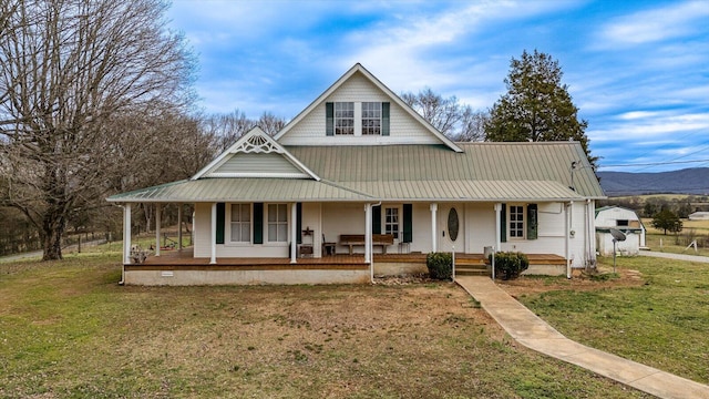 farmhouse inspired home with a front lawn and covered porch