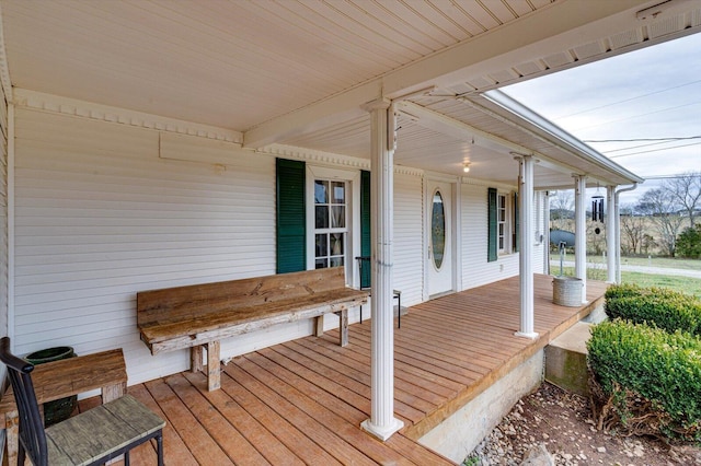 wooden terrace featuring covered porch