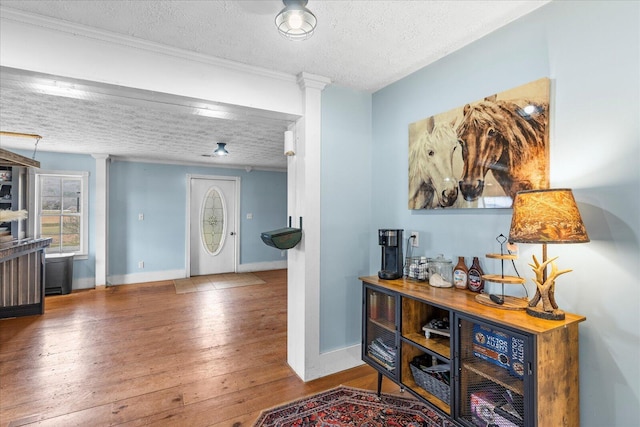 entryway with hardwood / wood-style flooring and a textured ceiling