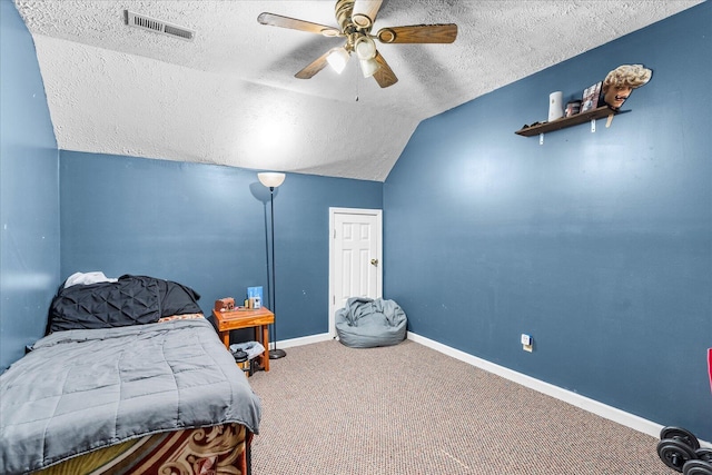 bedroom with ceiling fan, lofted ceiling, carpet flooring, and a textured ceiling