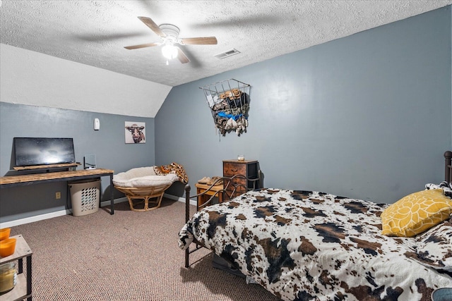 carpeted bedroom featuring ceiling fan, vaulted ceiling, and a textured ceiling