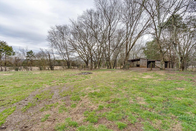 view of yard featuring a rural view and an outdoor structure