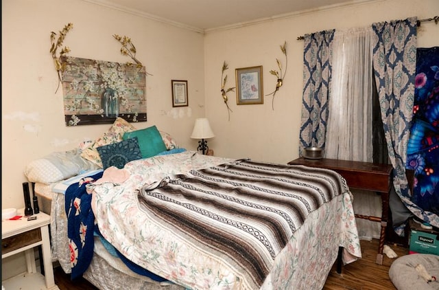 bedroom with ornamental molding and hardwood / wood-style floors