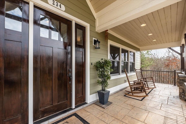 entrance to property featuring covered porch