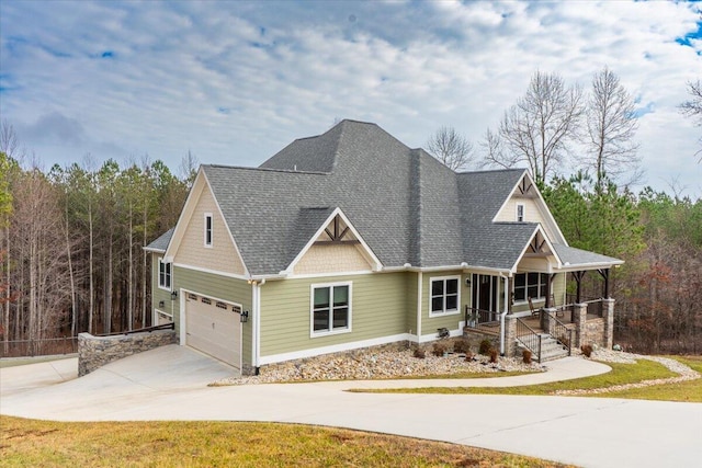 craftsman house with a porch, concrete driveway, a shingled roof, and an attached garage