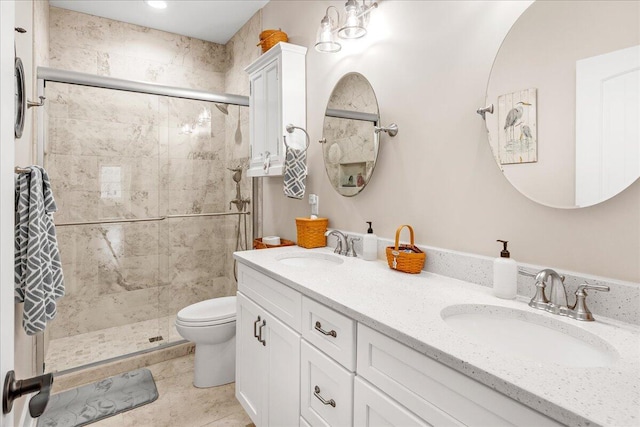 bathroom with toilet, a shower stall, and a sink