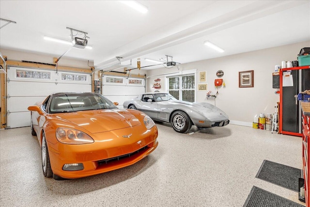 garage with a garage door opener and baseboards