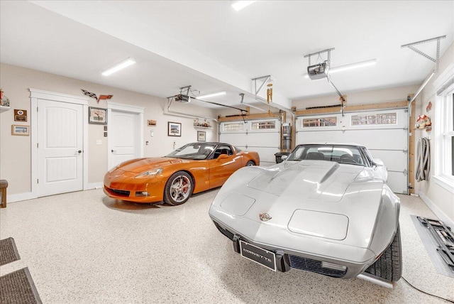 garage featuring a garage door opener and baseboards