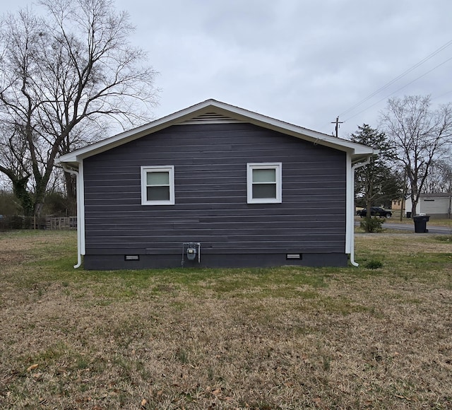 view of side of home featuring a lawn