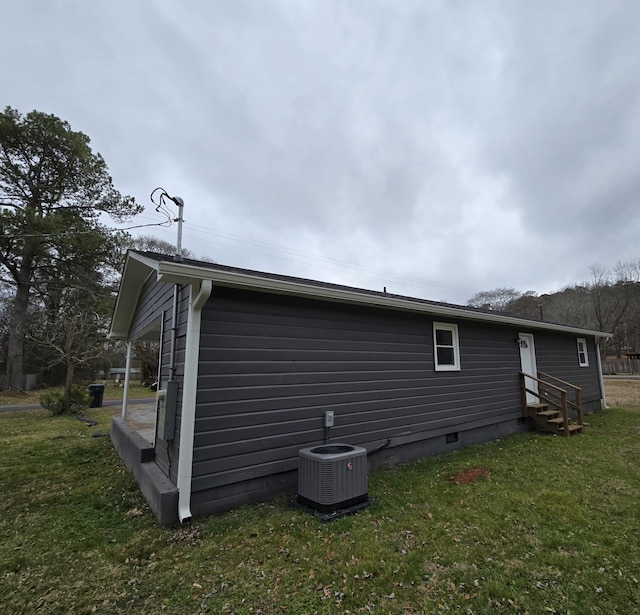 view of home's exterior with a yard and central air condition unit