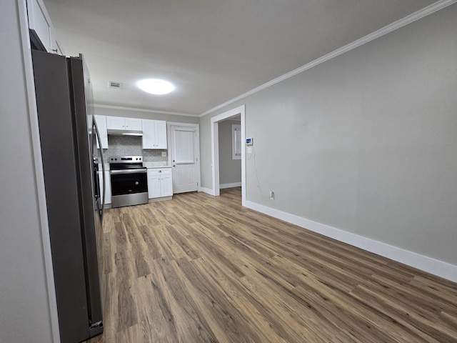 kitchen featuring white cabinetry, crown molding, tasteful backsplash, light hardwood / wood-style flooring, and appliances with stainless steel finishes