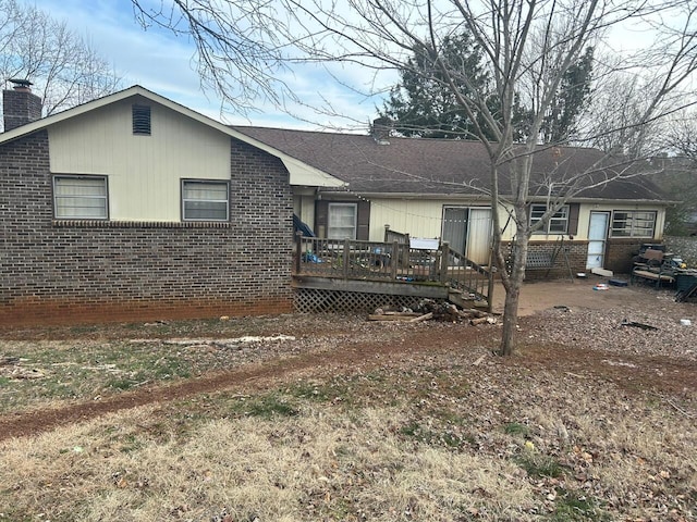 back of property featuring a deck