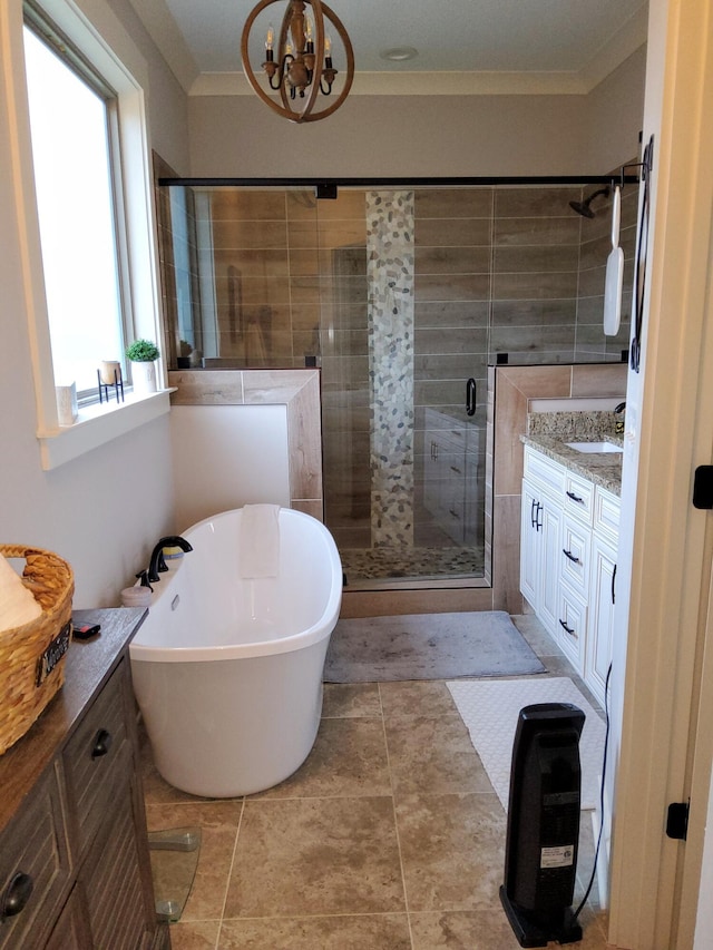 bathroom featuring vanity, ornamental molding, a chandelier, and separate shower and tub