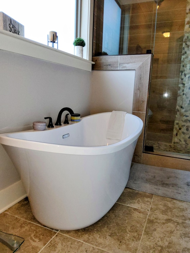 bathroom featuring tile patterned flooring and separate shower and tub