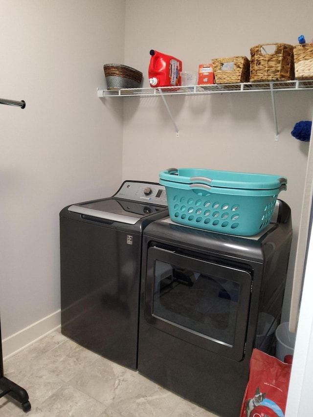 clothes washing area featuring washing machine and clothes dryer