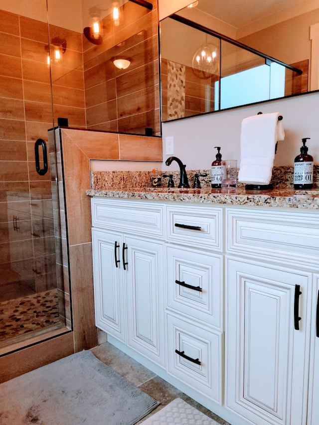 bathroom with vanity and a shower with door