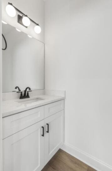 bathroom with vanity and wood-type flooring