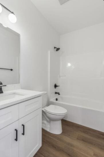 full bathroom with vanity, hardwood / wood-style flooring, toilet, and shower / bath combination