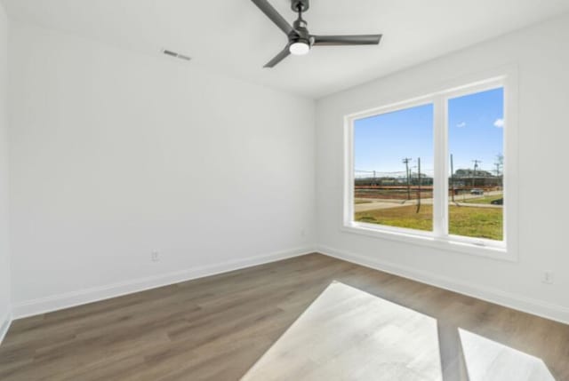 spare room featuring ceiling fan and dark hardwood / wood-style flooring