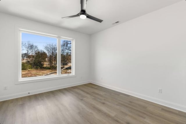 unfurnished room featuring hardwood / wood-style flooring and ceiling fan