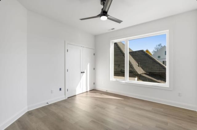 unfurnished room featuring hardwood / wood-style flooring and ceiling fan