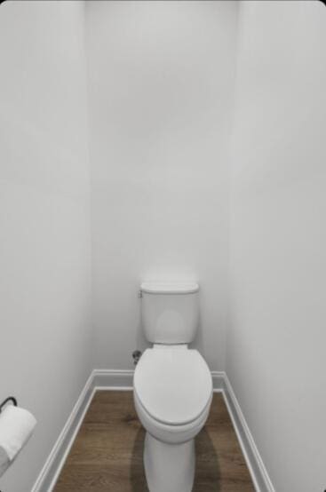 bathroom with wood-type flooring and toilet