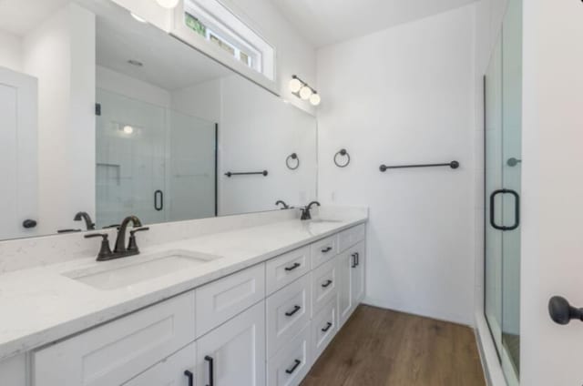 bathroom featuring vanity, hardwood / wood-style floors, and an enclosed shower