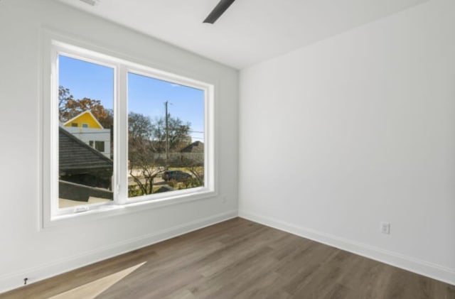 spare room featuring ceiling fan and dark hardwood / wood-style floors