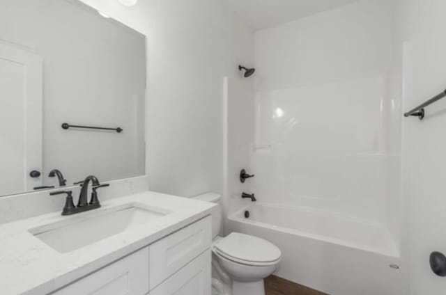 full bathroom featuring vanity, bathing tub / shower combination, and toilet