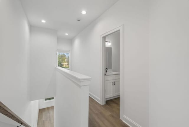 hall featuring sink and hardwood / wood-style floors