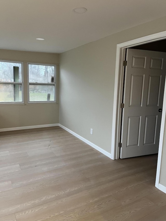 unfurnished room with light wood-type flooring