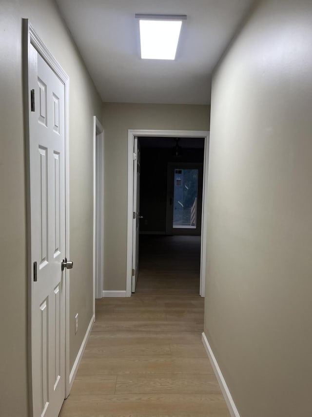 hallway with light hardwood / wood-style flooring