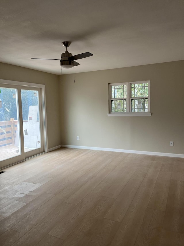 empty room with ceiling fan and light wood-type flooring