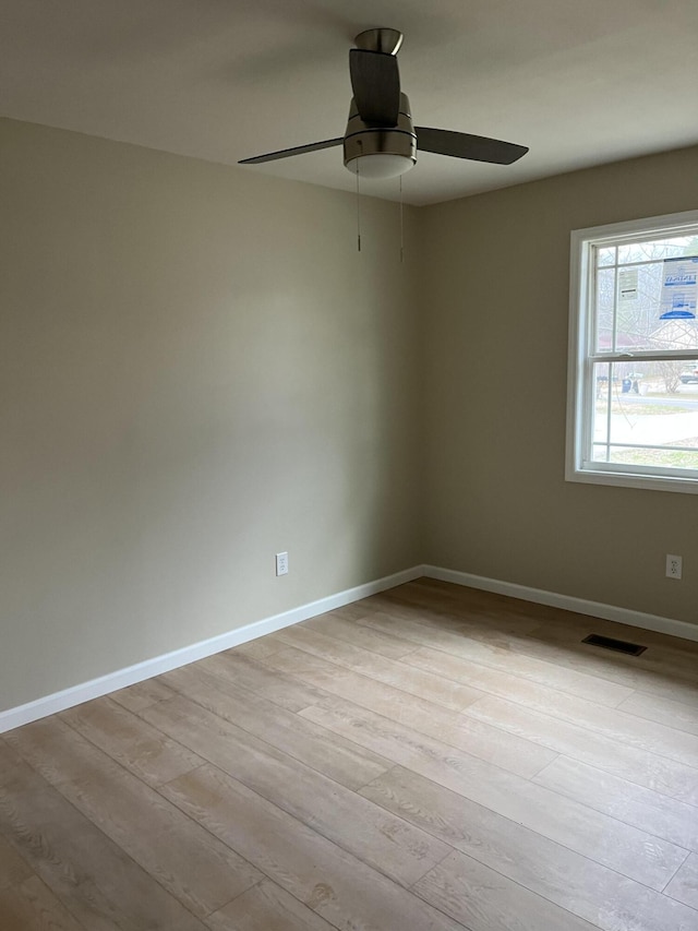 empty room with light hardwood / wood-style floors and ceiling fan