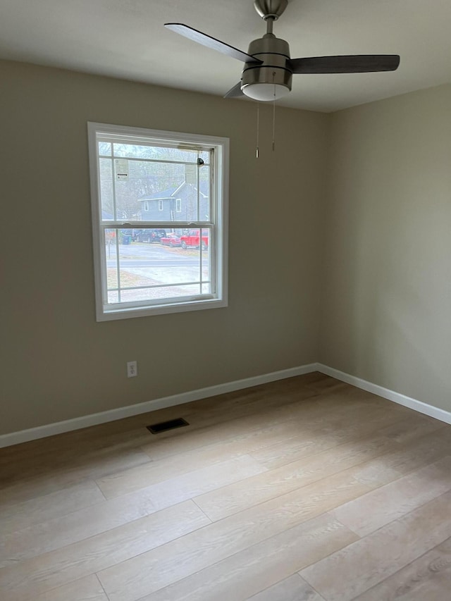 empty room featuring ceiling fan and light hardwood / wood-style flooring