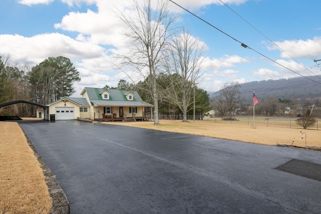 view of front of property featuring a garage, a front yard, and covered porch