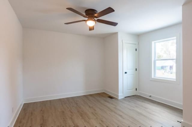 empty room featuring ceiling fan and light hardwood / wood-style floors