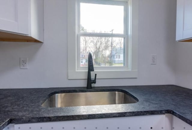 kitchen with white cabinetry and sink