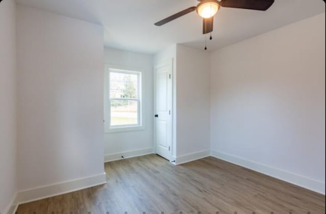 unfurnished room featuring ceiling fan and light hardwood / wood-style flooring