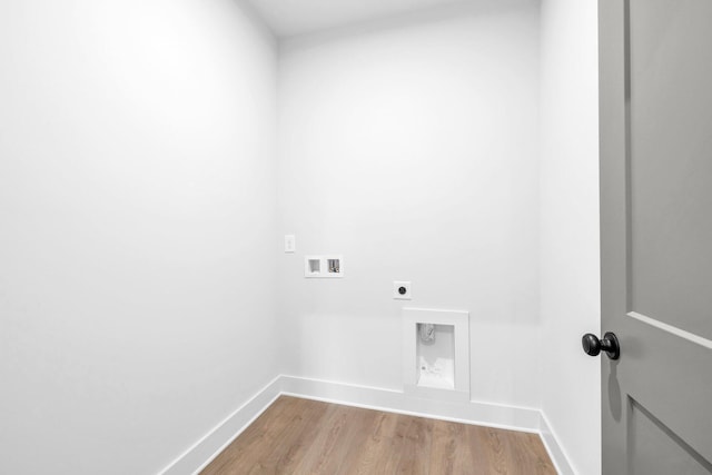 clothes washing area featuring washer hookup, hookup for an electric dryer, and light hardwood / wood-style floors