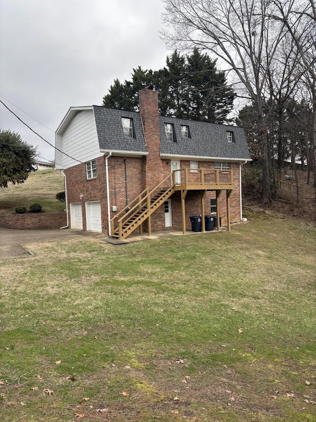 back of house featuring a wooden deck, a garage, and a yard